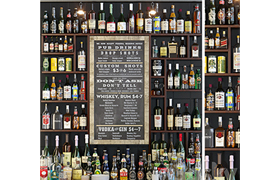 Showcase in the bar with a collection of strong alcohol and